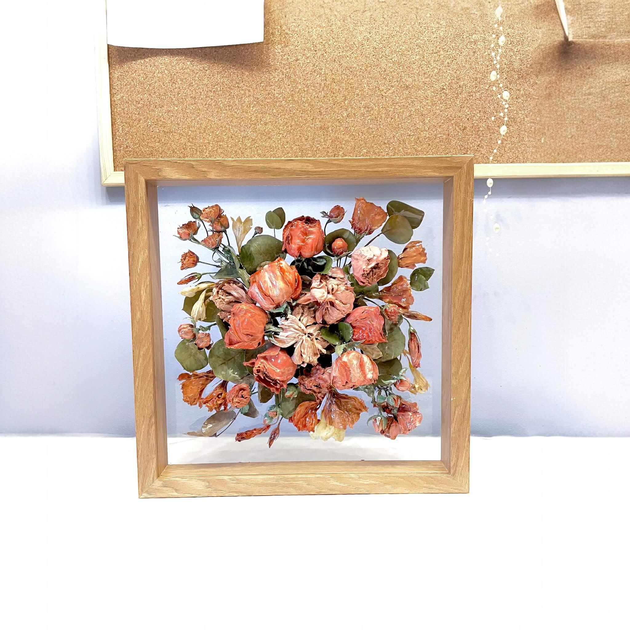 Shadowbox with preserved wedding flowers in light wood frame