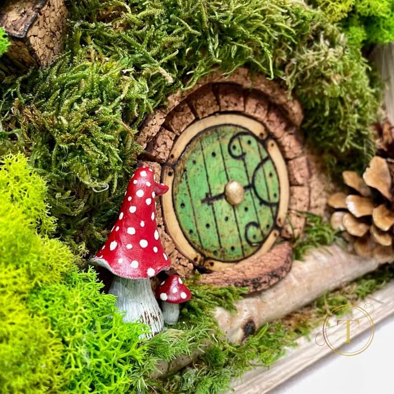 Detail view of handcrafted red toadstools adjacent to a charming Hobbit House