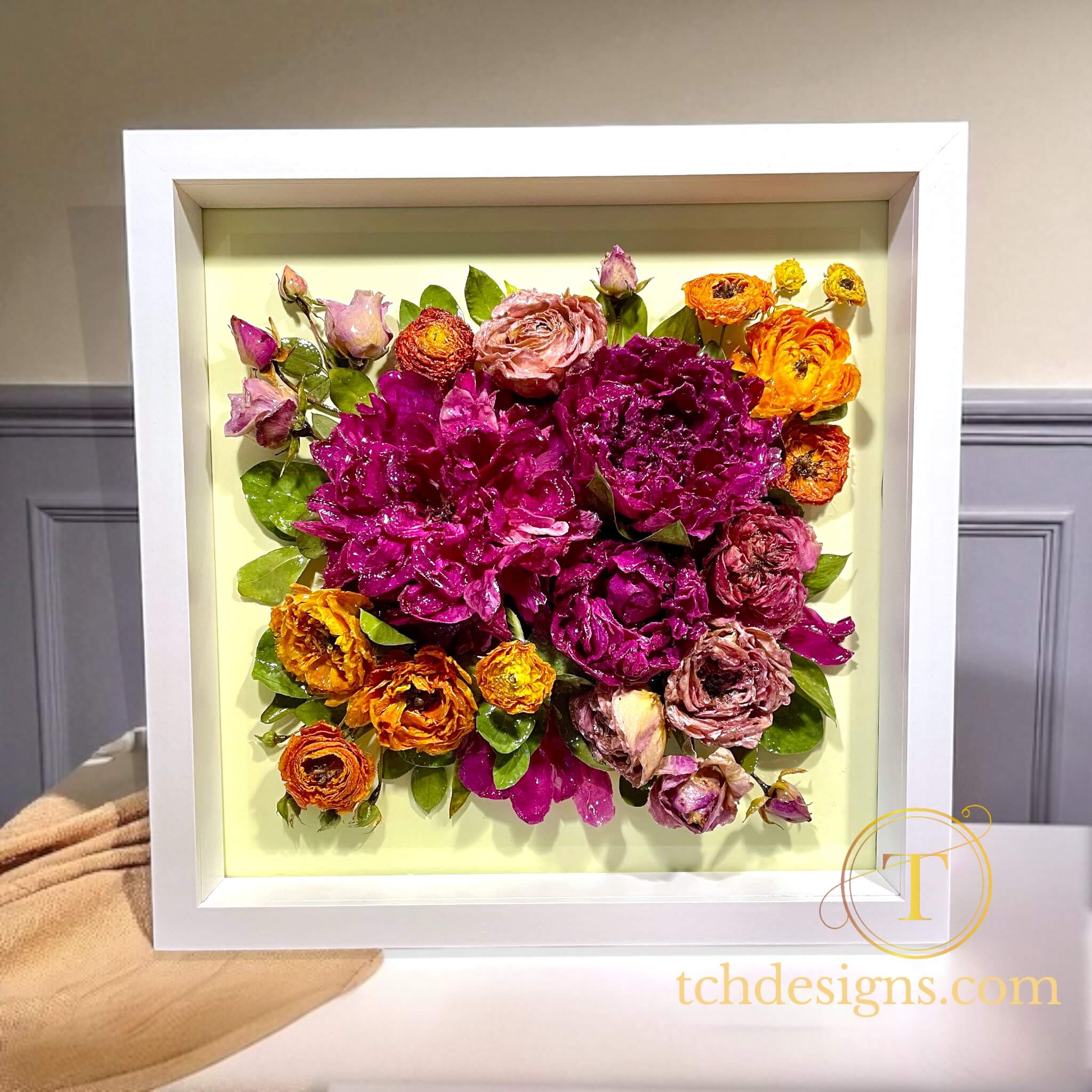 Framed bouquet of colorful flowers with a white border