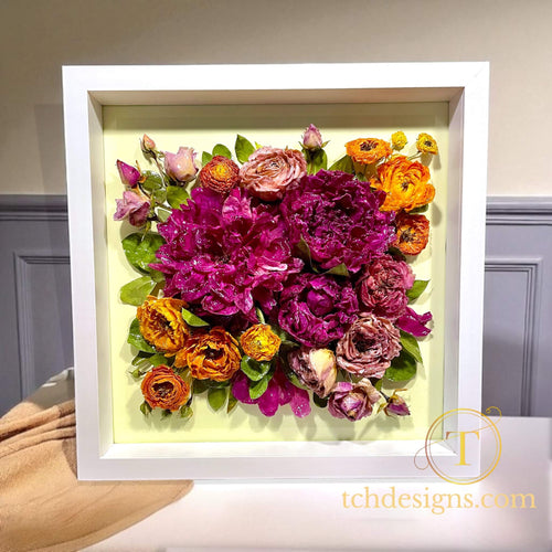 Framed bouquet of colorful flowers with a white border