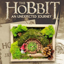 Hobbit House with Bilbo Baggins-style round door, preserved moss art on Tolkien’s book background.