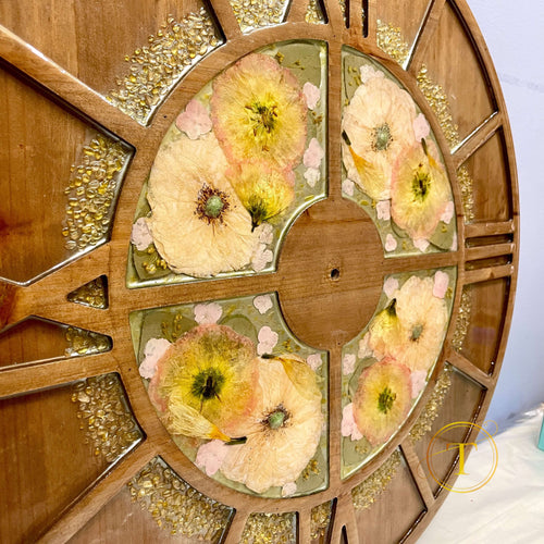 Close-up of dried flowers in resin – custom floral clock detail.