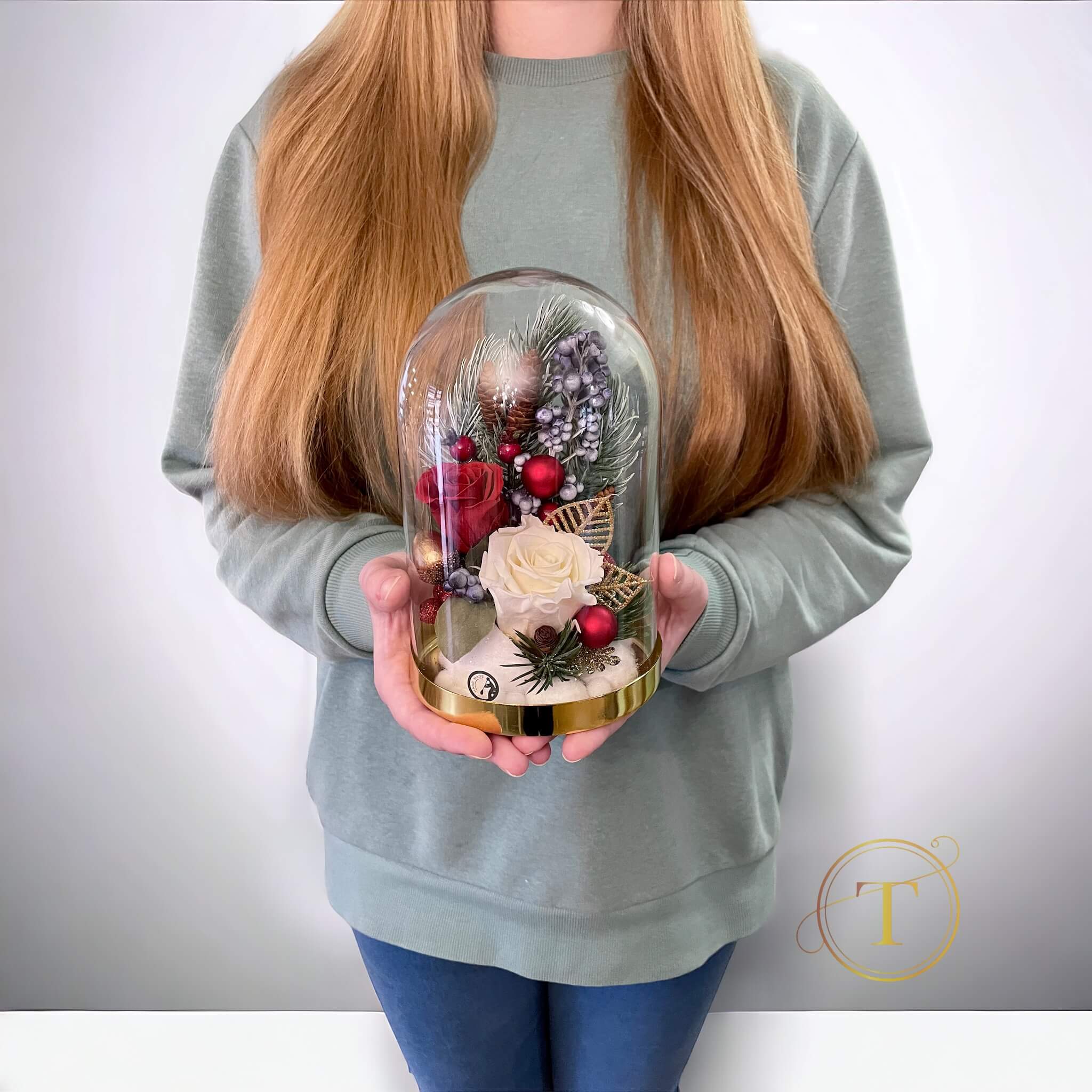 Glass dome roses arrangement in hands