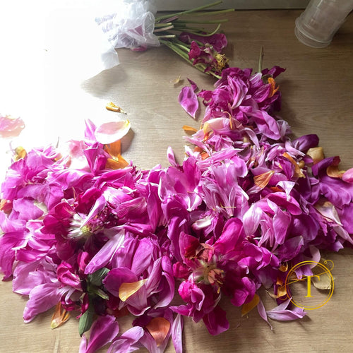 Purple flowers scattered on a wooden surface