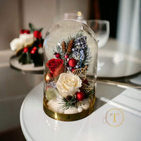 Glass dome with roses on a white table