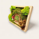 Side view of a Hobbit-inspired mossy scene with pine cones and toadstools